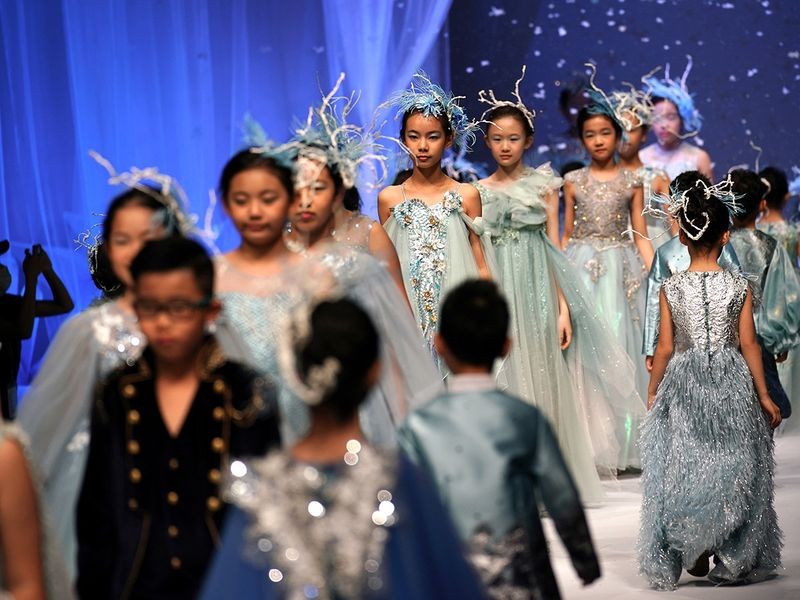 Over the weekend, crowds packed a former industrial warehouse in Beijing as the China fashion Week got underway, with models strutting mask-less on a square runway and guests oblivious to social distancing norms. Image Credit: REUTERS